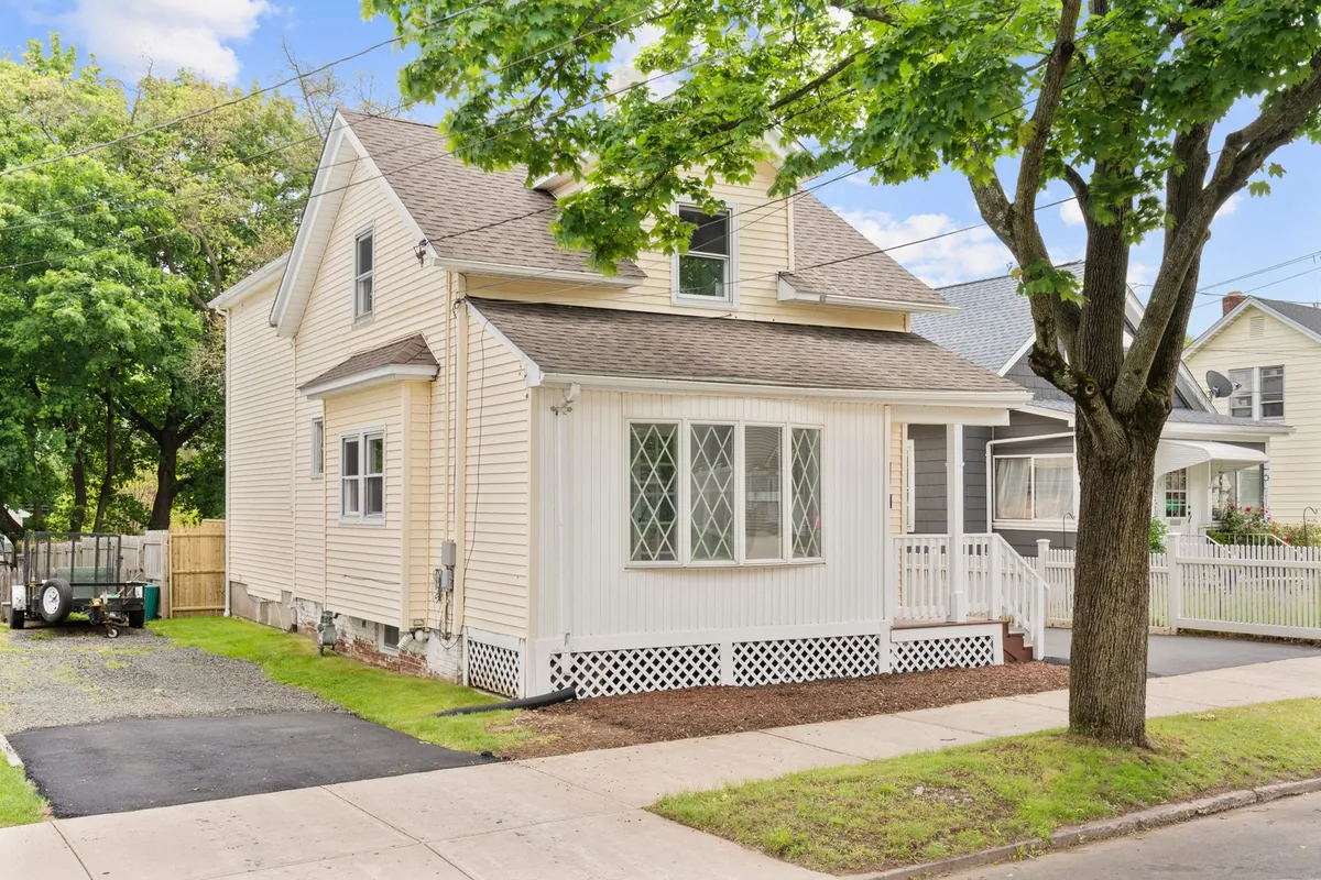 A cream two-storey house with a bay window on Oakley Street in New Haven, bought by Next Door Properties