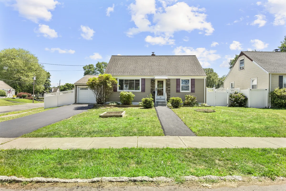 A grey Cape Cod house on Burdette Place in Milford, bought by Next Door Properties