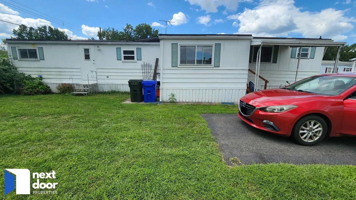 A white manufactured home on Apache Road in East Hartford, bought by Next Door Properties