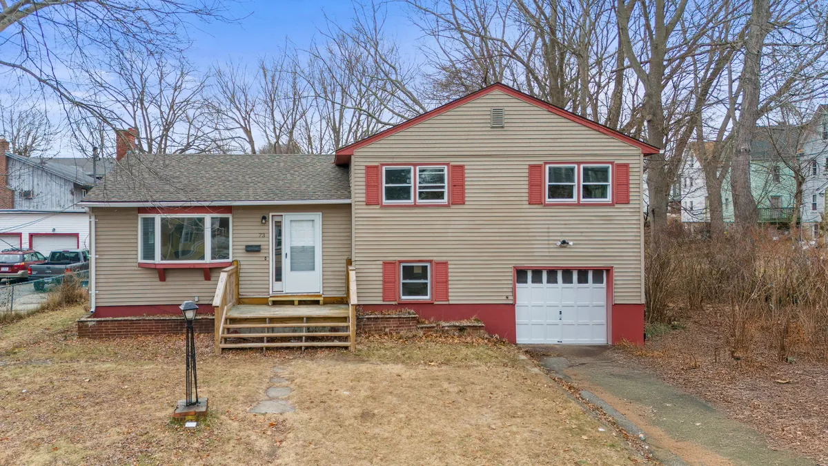 A split-level house with a garage on Lincoln Avenue in New London, bought by Next Door Properties